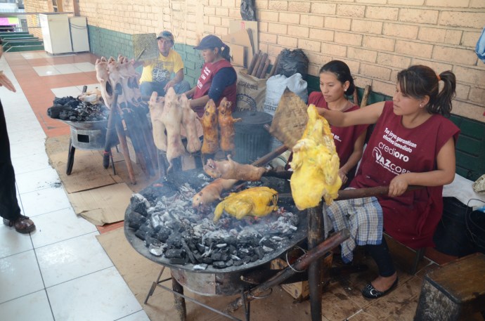 Cuy (guinea pig) and pollo (chicken) roasting over an open fire.