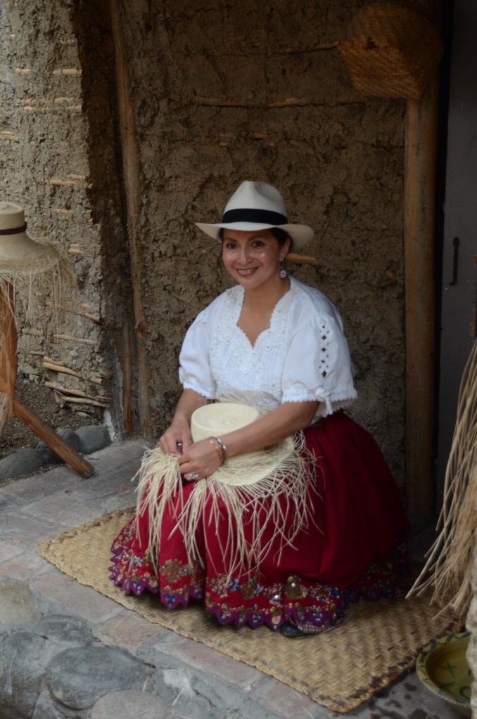 A lovely chola cuencana shows how hats are woven from straw.  In reality, the weaving is not done at the hat factory.  Women create the hats at home, then sell them to the factories for a small price.