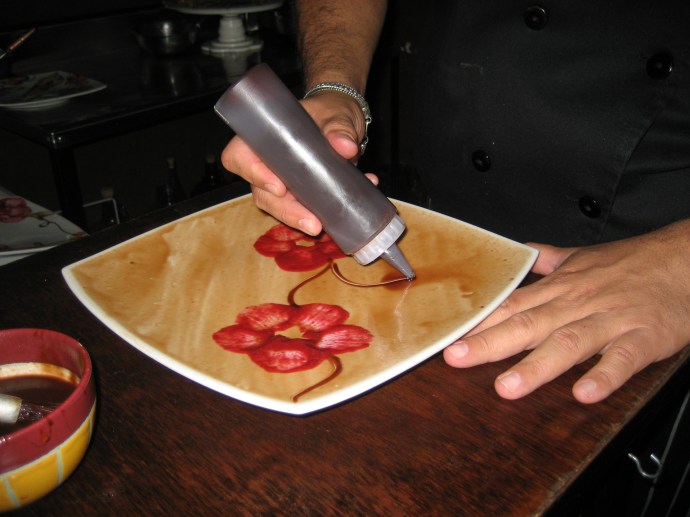 Here a different plate is being prepared.  Liquid chocolate has been painted as a background.
