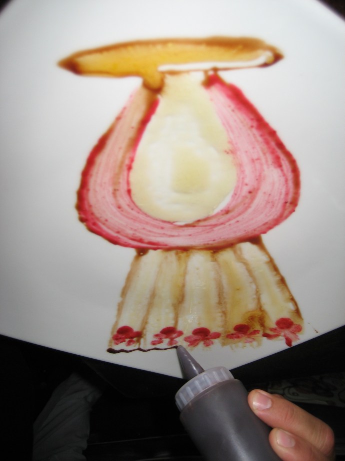 Step 7 -- Chef Carlos then uses liquid chocolate in an applicator bottle to provide detail.