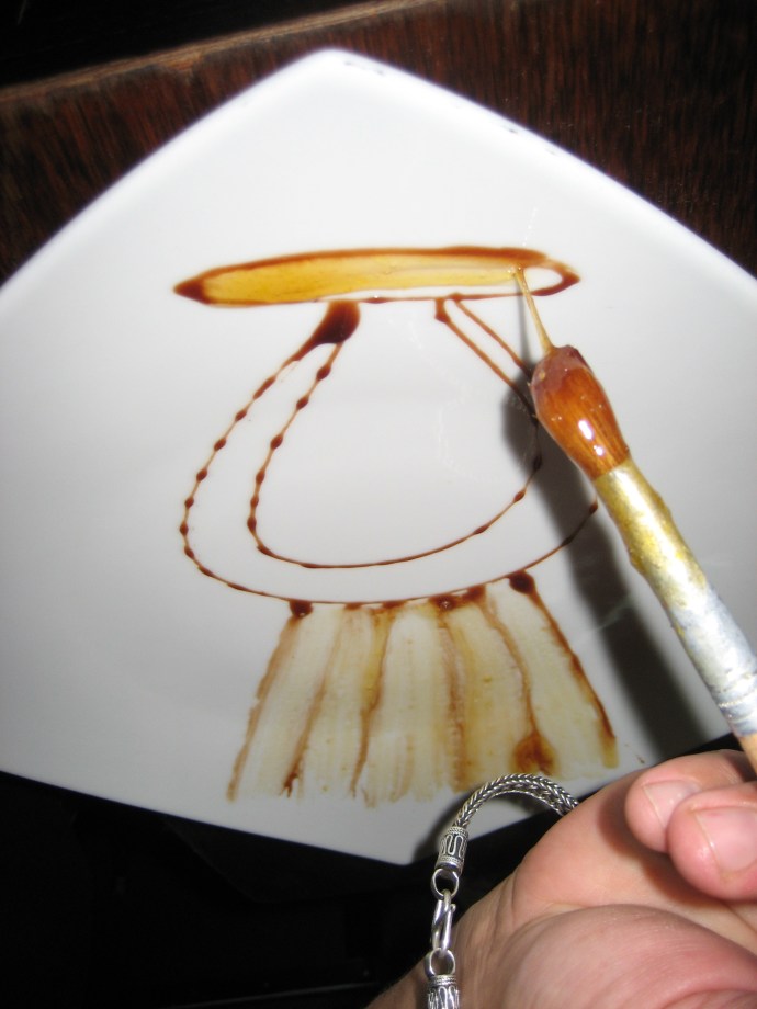 Step 4 -- after painting the bottom, he begins work on the top of the design.