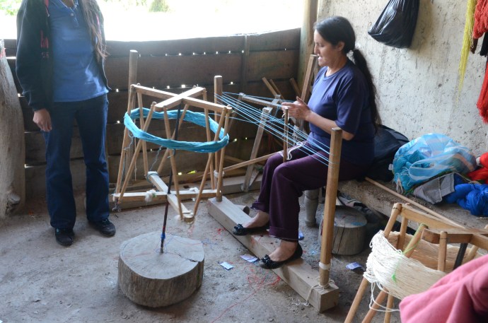 Using a handmade machine to make a skein of wool