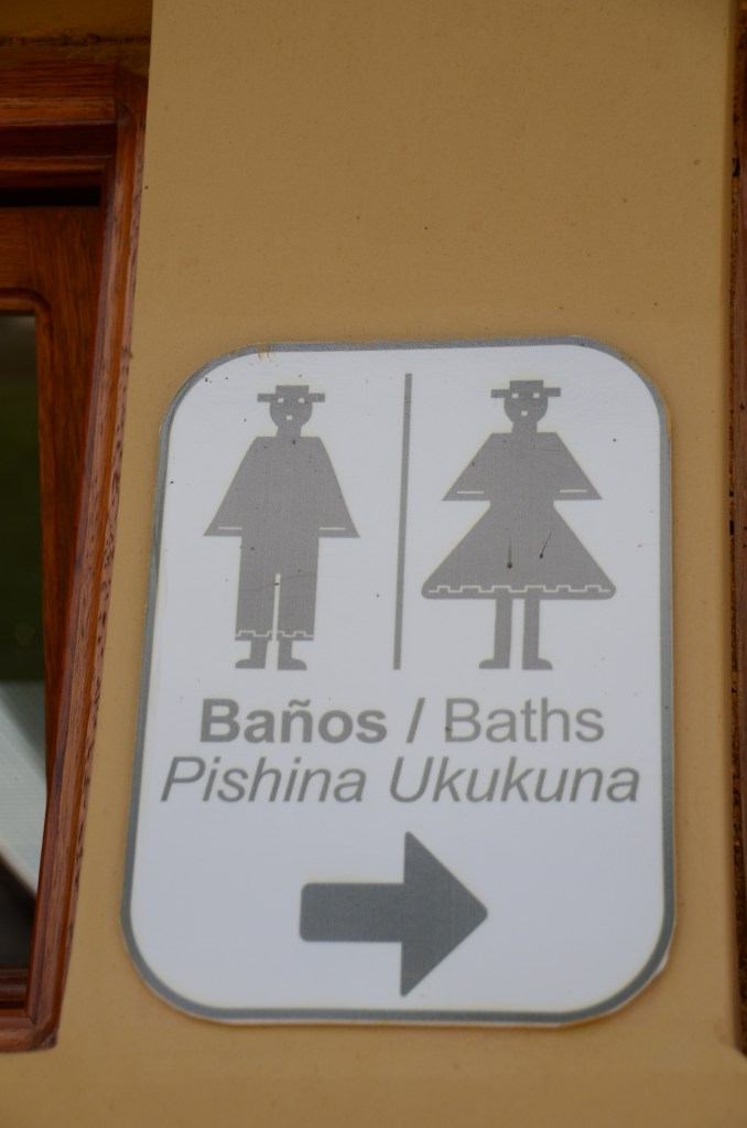 Bathroom sign in Spanish, English, and Quichua -- most signs at Ingapirca had all three languages