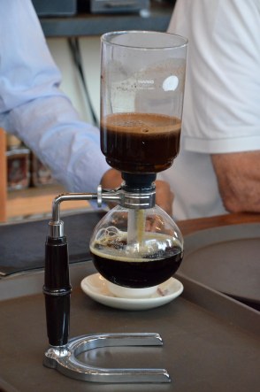 A siphon coffee maker, about halfway through the brewing process.