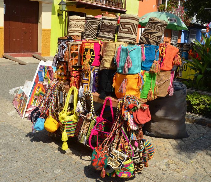 Bags woven from caña flecha braids. The ones in the top row are the more traditional colors